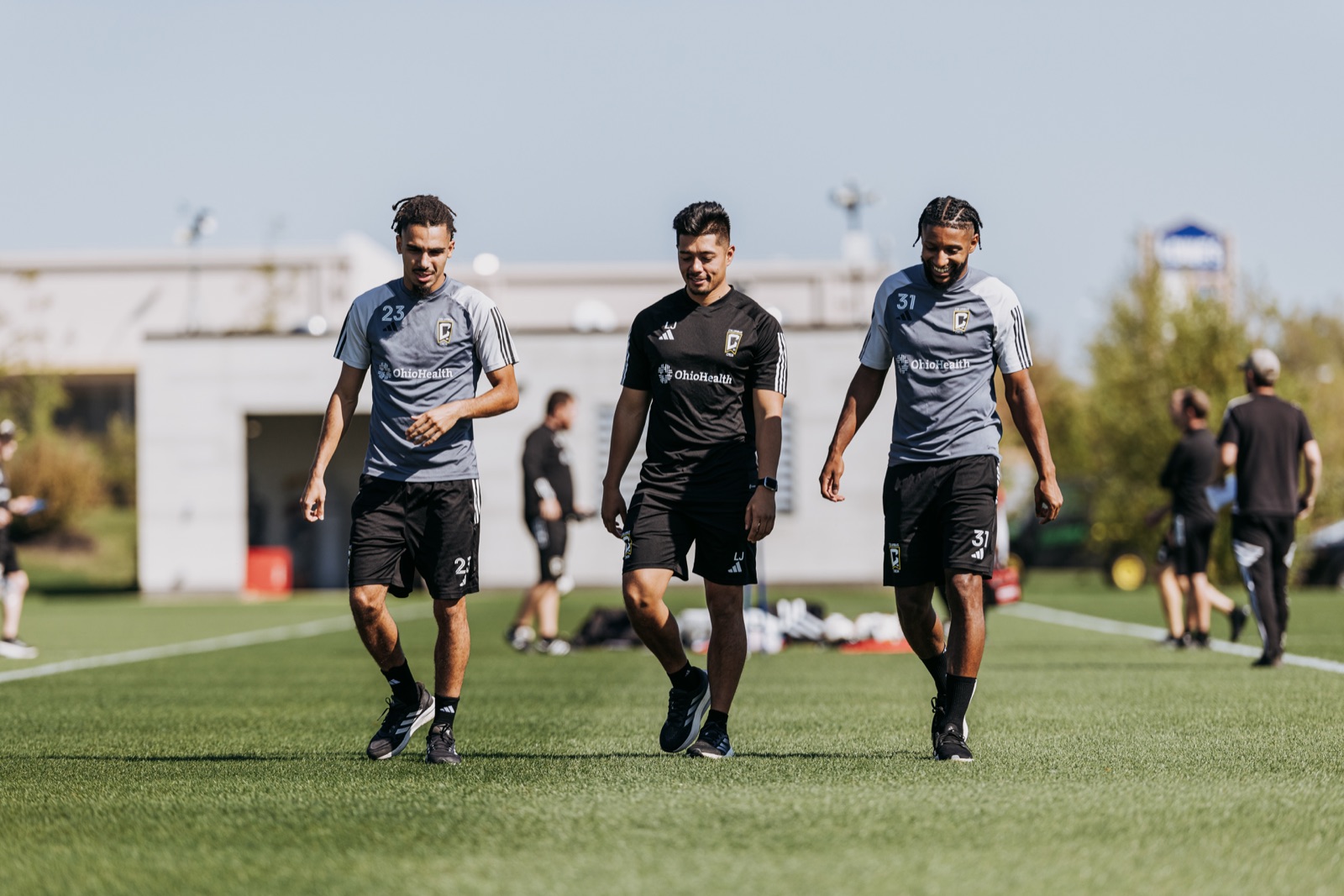 Luis alongside professional players on the training field
